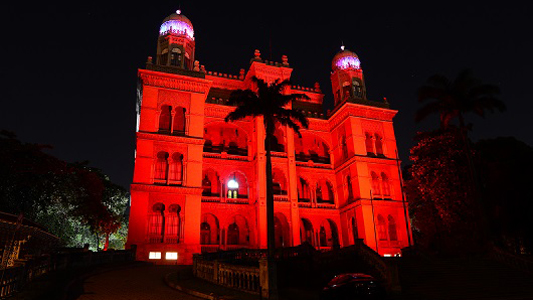 Castelo da Fiocruz iluminado por luz vermelha