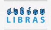 Imagem com fundo branco com símbolos e mãos representando as letras da linguagem brasileira de sinais escrevendo LIBRAS